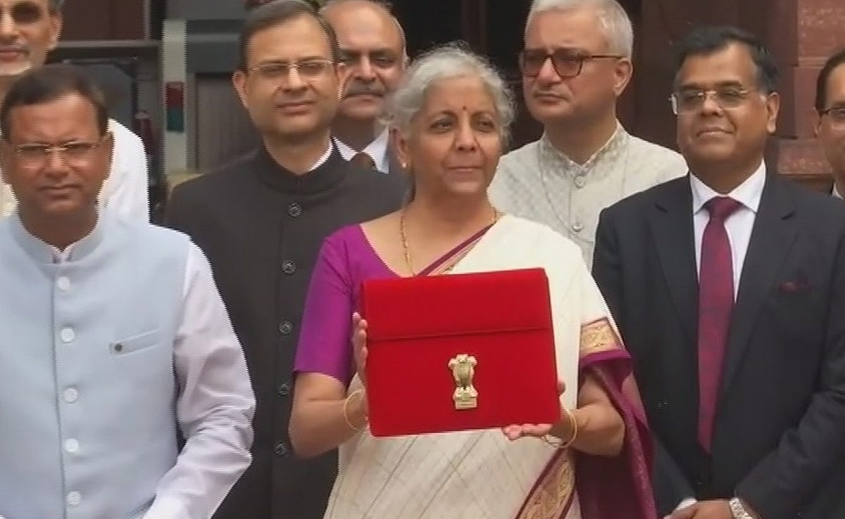 Finance Minister Poses With Tablet In Red Sleeve Ahead Of Budget Speech