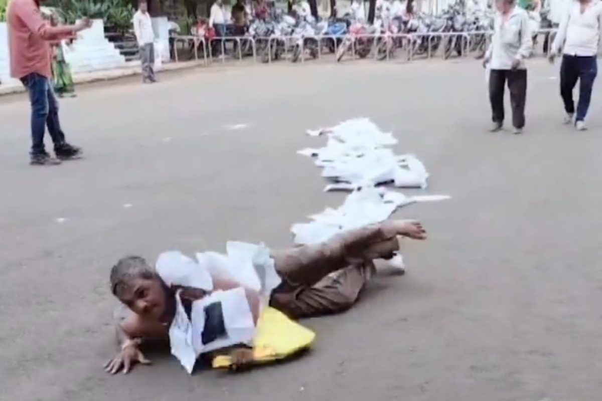 MP Man Rolls To Collector’s Office With Documents Around His Neck To Protest Corruption | Watch