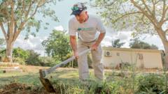 Keeping lawns neat in front of burned homes – a year on at kibbutz where Hamas killed 101