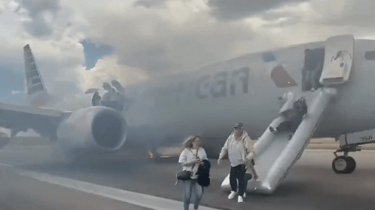 American Airlines passengers flee via slides as smoke engulfs plane