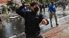 Protesters and police clash after death of taxi driver in Indonesia